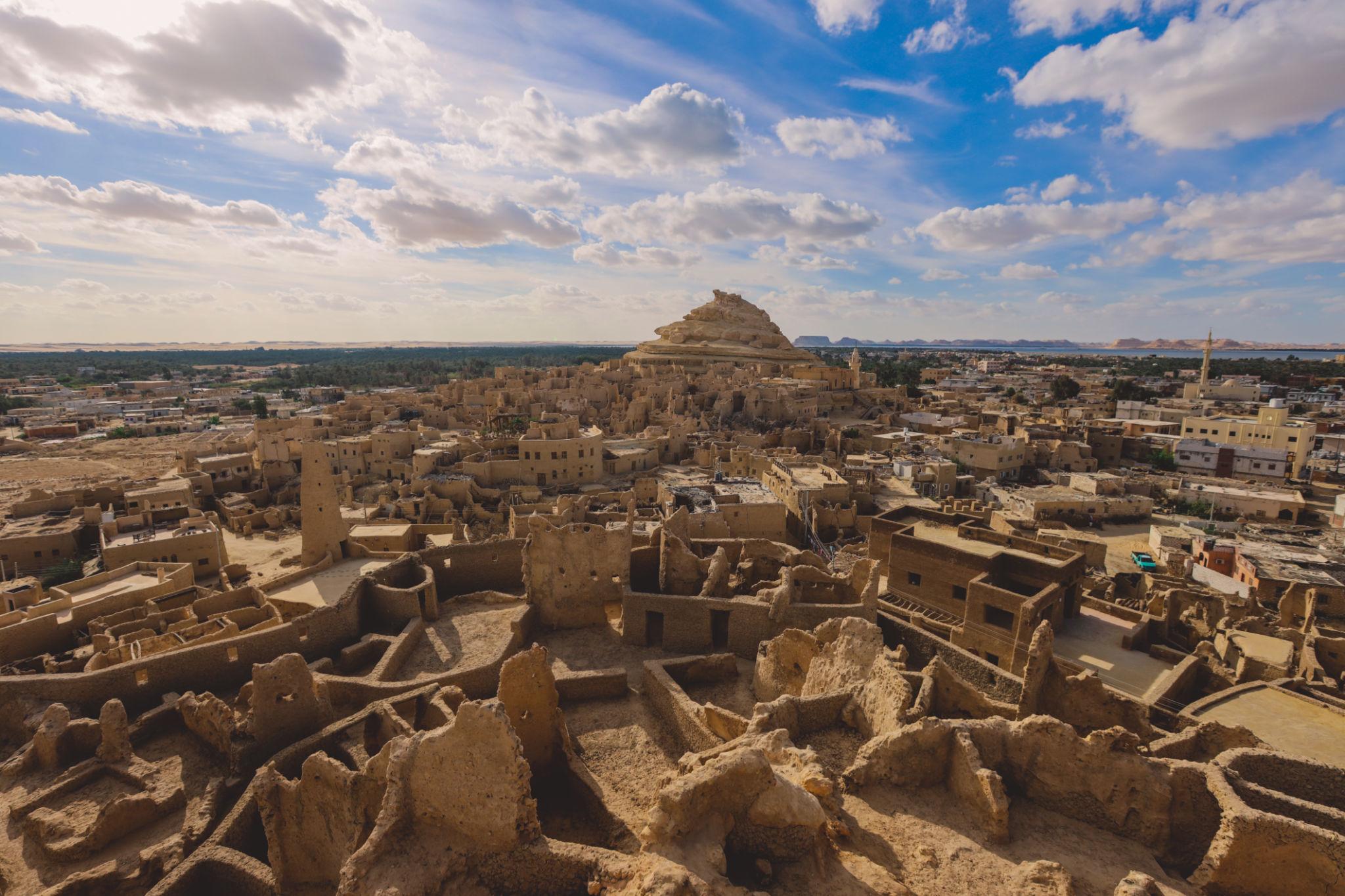 Aerial view of Siwa's ancient mud-brick Shali Fortress ruins rising above the desert oasis town