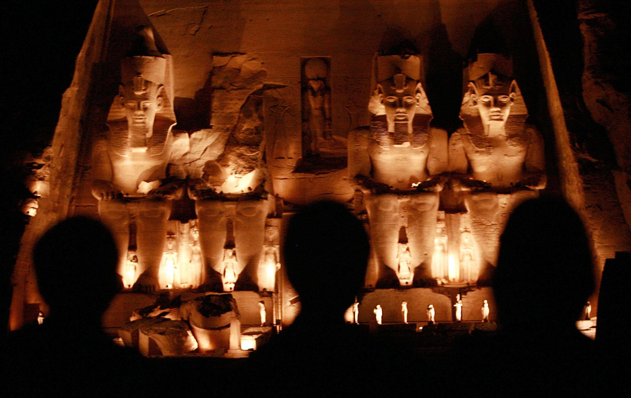 Four colossal statues of Ramesses II illuminated at night at Abu Simbel temple