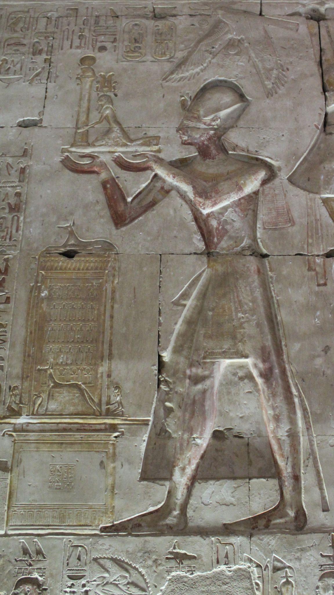 Relief of pharaoh Seti I presenting an offering stand to a deity at Abydos.