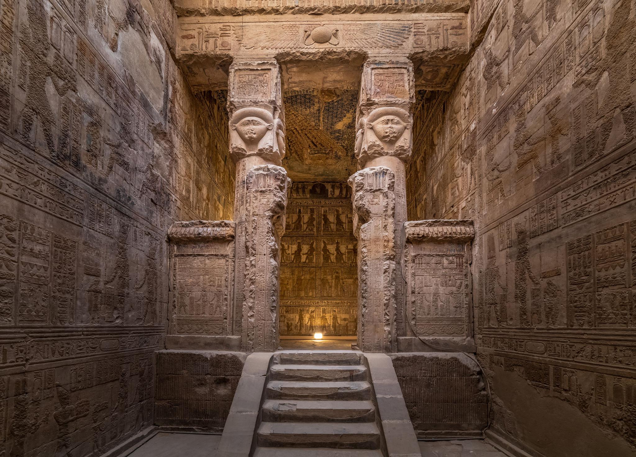 Inner sanctuary doorway flanked by Hathor-headed pillars at Dendera Temple.
