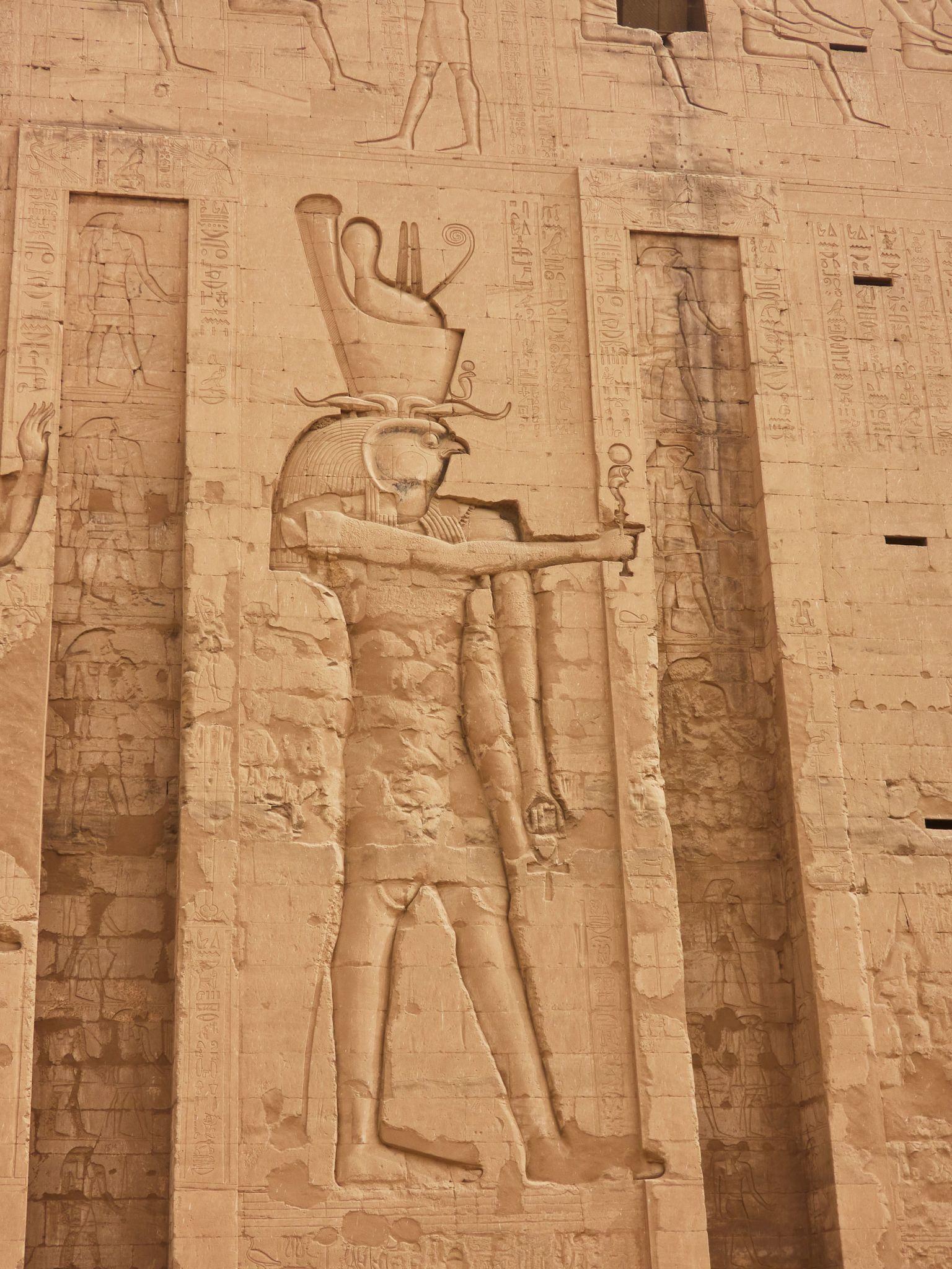 Monumental relief of Horus carved into the Temple of Edfu pylon wall.