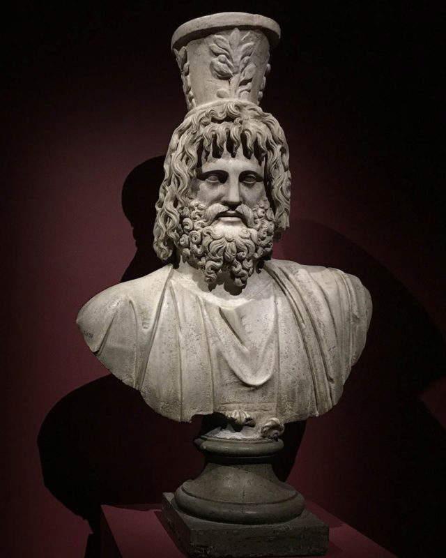 Marble bust of Serapis with calathos crown, a syncretic Greco-Egyptian deity on display