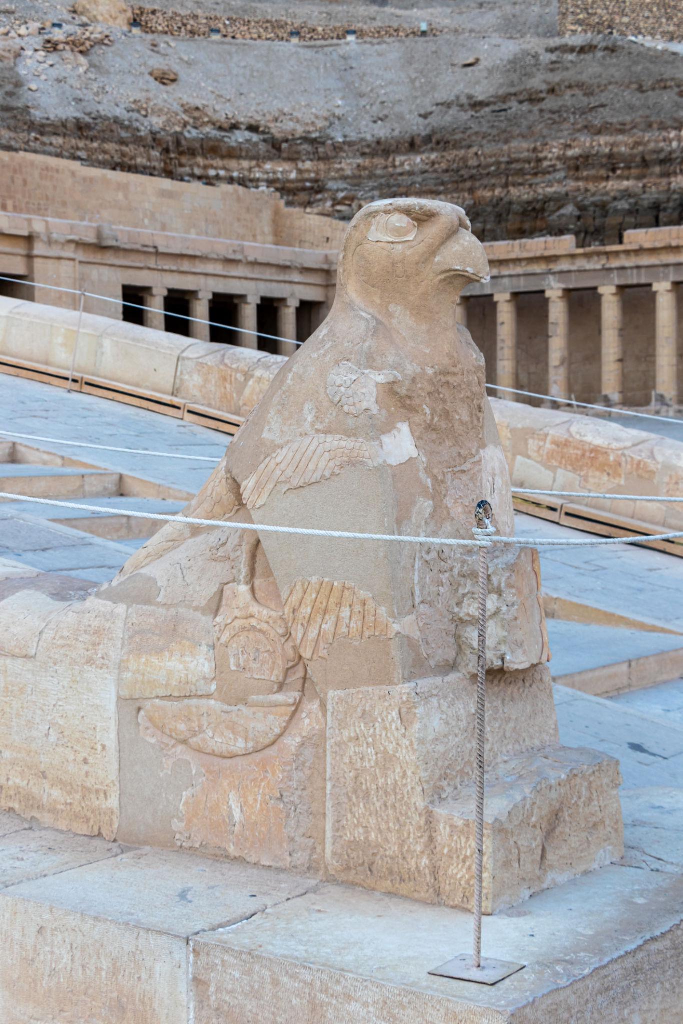 Horus falcon guardian statue on terrace overlooking Hatshepsut Temple colonnade