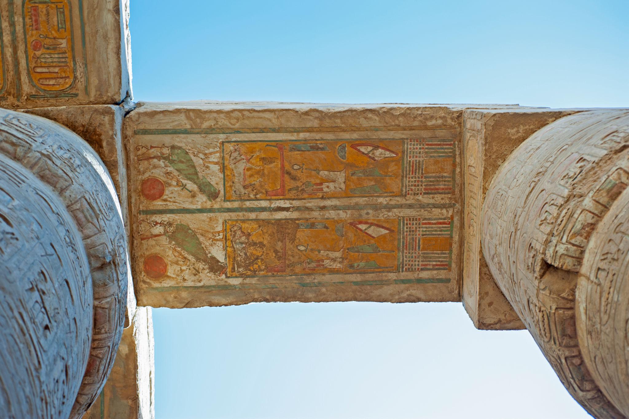 Brightly painted architrave relief between column tops at Karnak Temple