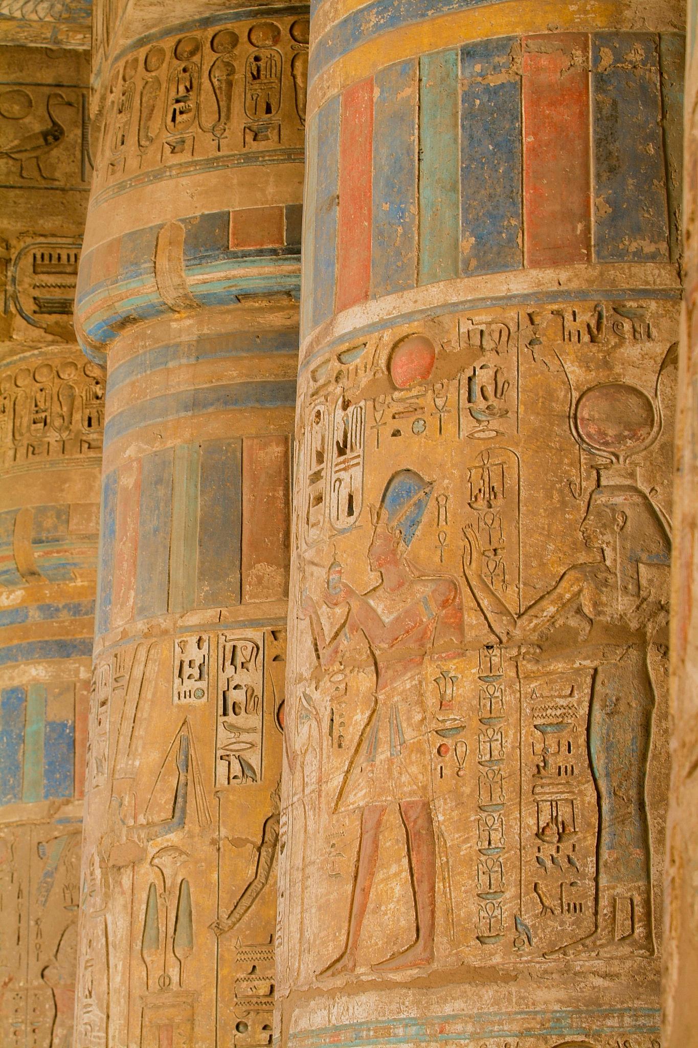 Painted relief of Ramesses III offering to a deity on a temple column at Medinet Habu.