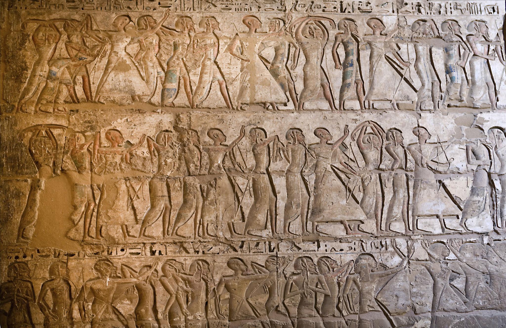 Wall relief depicting processions of bound foreign prisoners at Medinet Habu.