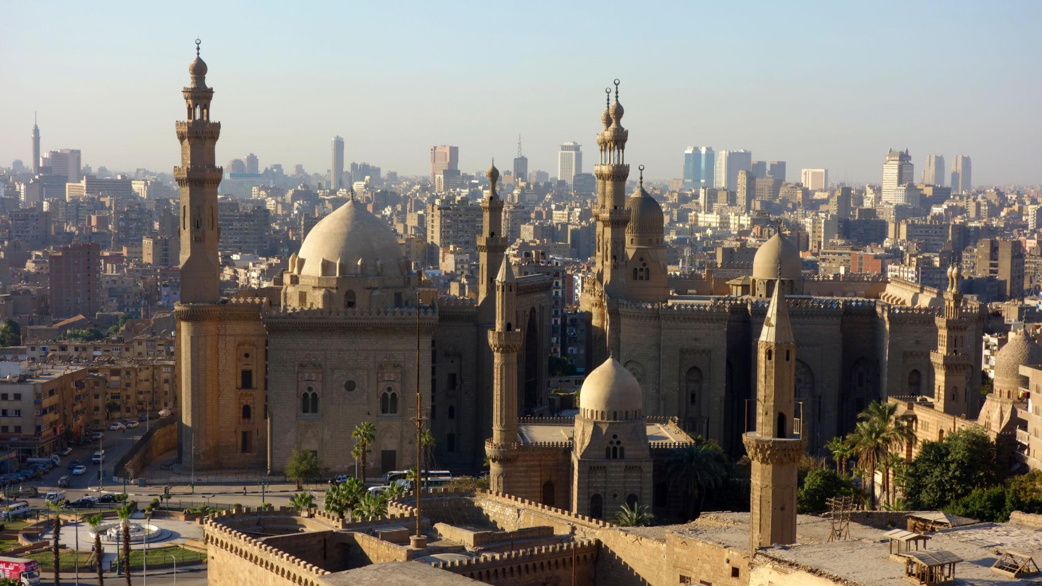 Monumental Sultan Hassan mosque domes and minarets rising above the Cairo skyline