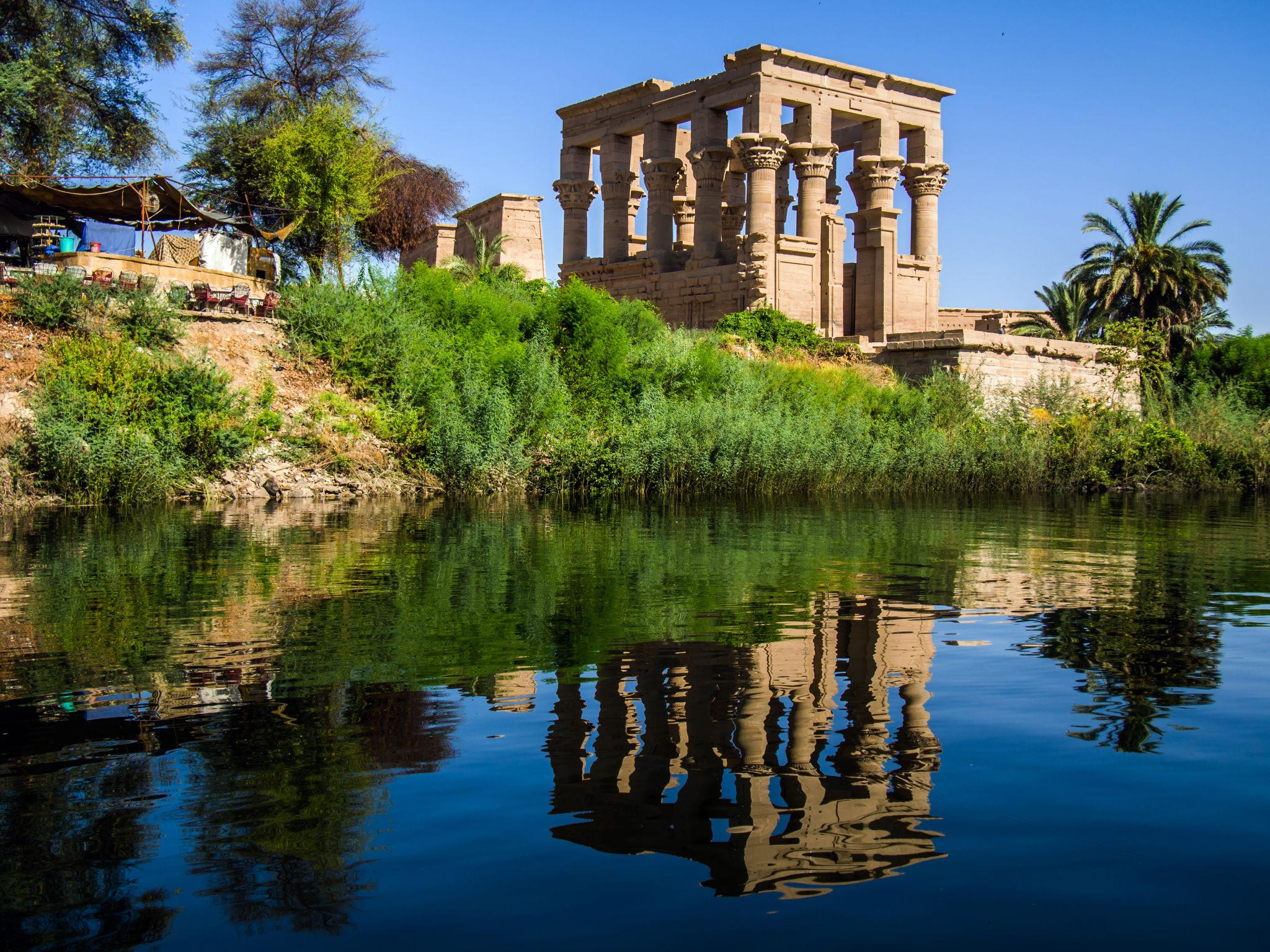 The Kiosk of Trajan at Philae Temple reflected in the calm Nile waters