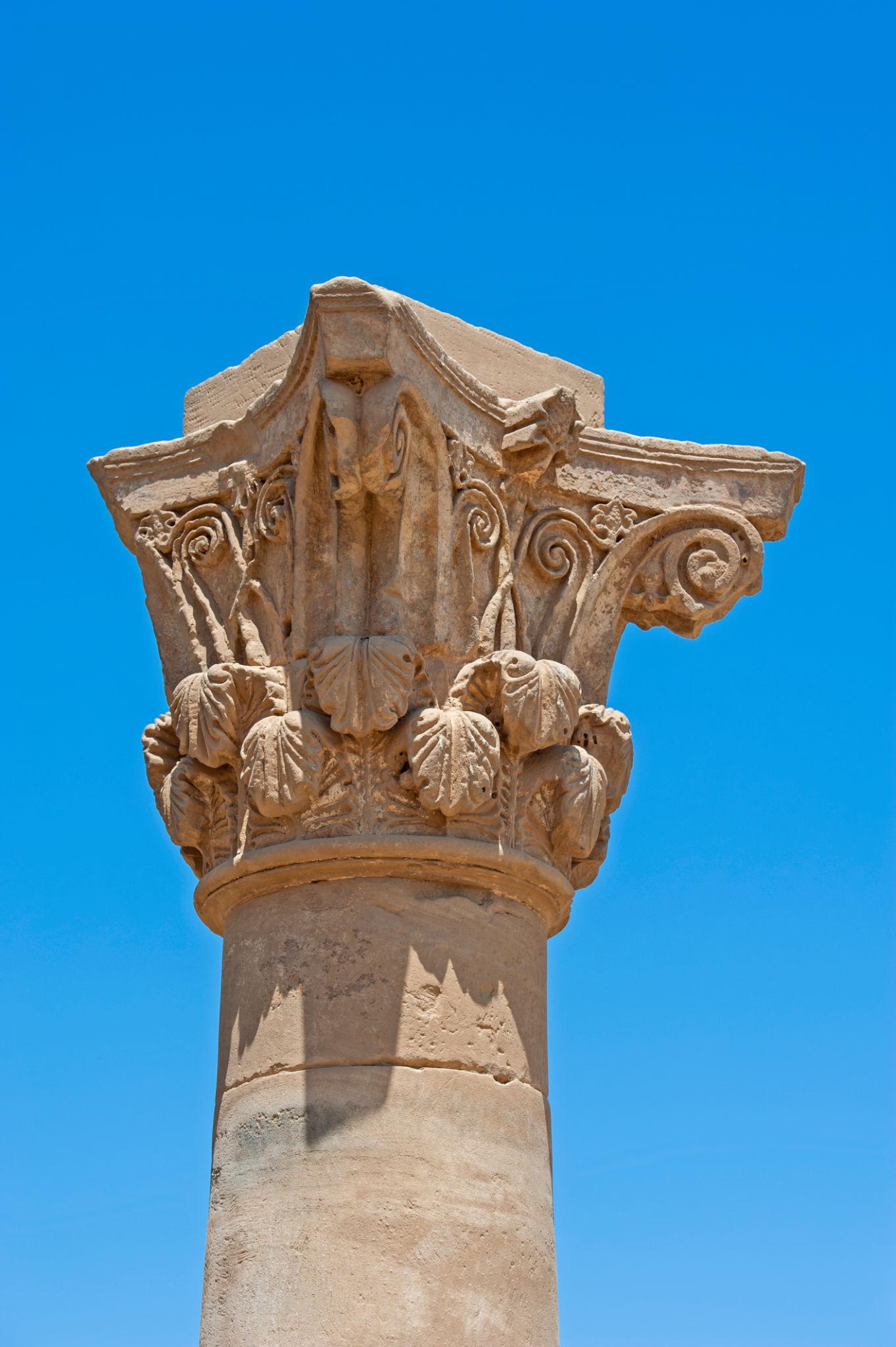 Close-up of the carved Corinthian capital crowning Pompey's Pillar against blue sky