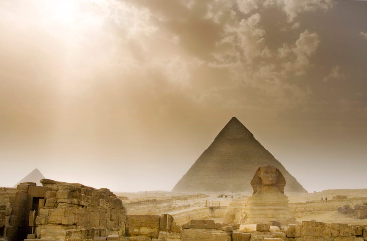 Misty view of the Sphinx beside the Pyramid of Khafre with soft diffused light