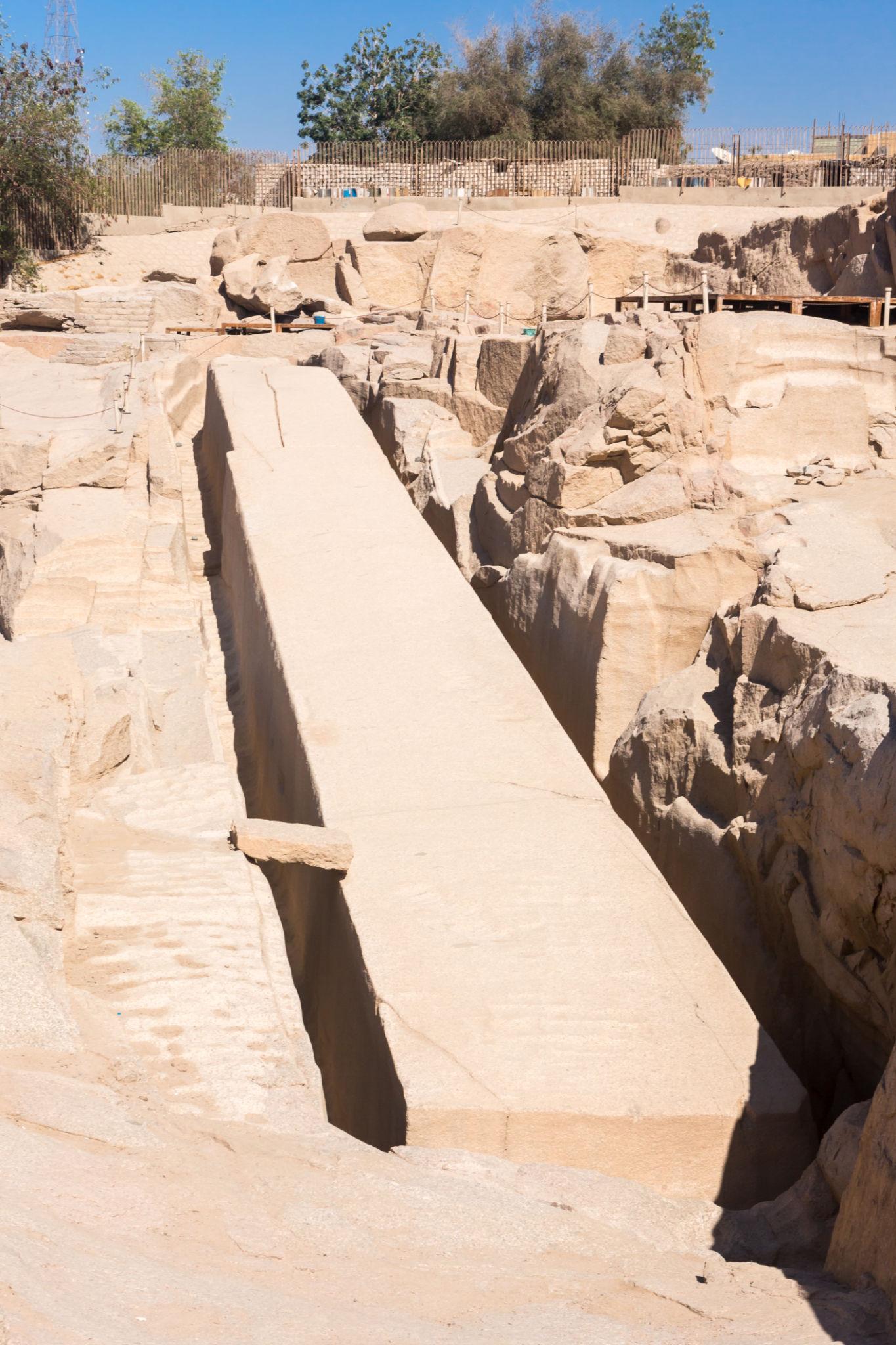 The massive unfinished obelisk still attached to bedrock in an ancient Egyptian granite quarry