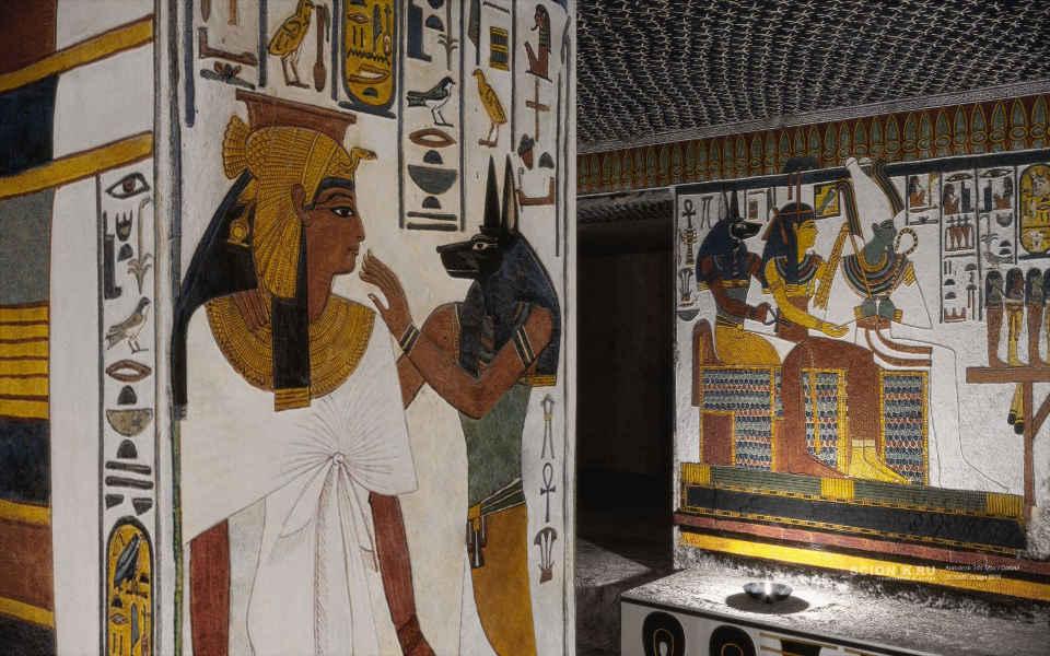 Nefertari facing Anubis on a painted pillar with an adjoining scene of seated gods.
