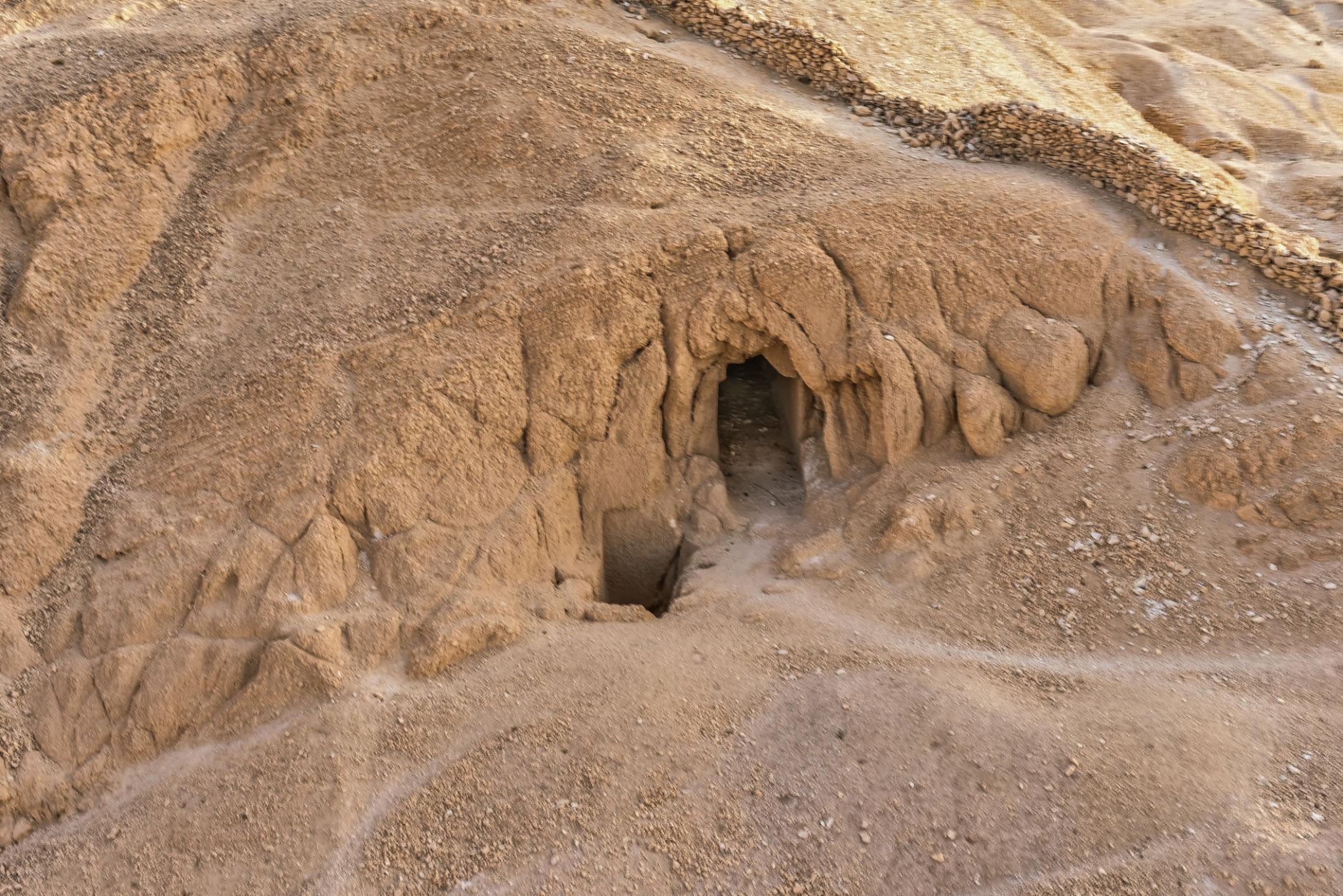 Unfinished rock-cut tomb opening in the barren cliffs of the Valley of the Queens.