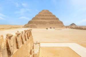 The Step Pyramid, Sakkara, Egypt: Saqqara, also spelled Sakkara in English, is an Egyptian village in Giza Governorate, that contains ancient burial grounds of Egyptian royalty, serving as the necropolis for the ancient Egyptian capital, Memphis. 
Saqqara contains numerous pyramids, including the Step Pyramid of Djoser, sometimes referred to as the Step Tomb, and a number of mastaba tombs. Located some 30 km (19 mi) south of modern-day Cairo, Saqqara covers an area of around 7 by 1.5 km (4.3 by 0.9 mi).

Saqqara contains the oldest complete stone building complex known in history, the Step Pyramid of Djoser, built during the Third Dynasty. Another sixteen Egyptian kings built pyramids at Saqqara, which are now in various states of preservation. High officials added private funeral monuments to this necropolis during the entire Pharaonic period. It remained an important complex for non-royal burials and cult ceremonies for more than 3,000 years, well into Ptolemaic and Roman times.