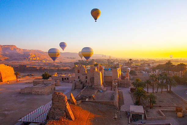 Hot air balloon flying above The Mortuary Temple of Ramesses III at Medinet Habu in Theban Necropolis at Valley of the Kings, Loxor, Egypt
